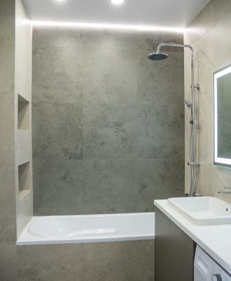 Bathroom interior with mirror and wash basin.